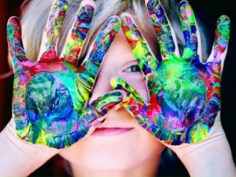 child with paint on hands